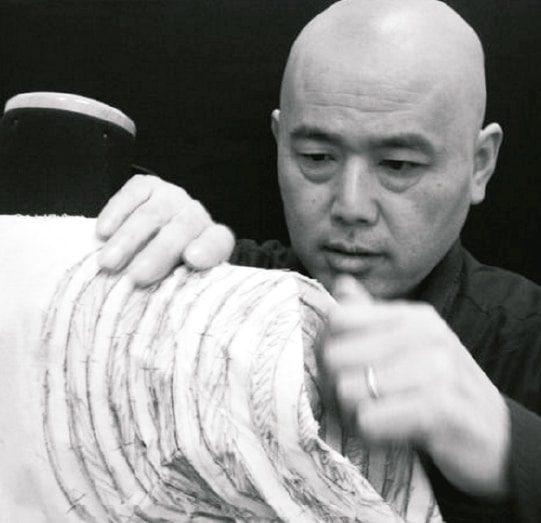 Master Shingo Sato sculpting a 3D Transformational Reconstruction spiral bust on a dress form